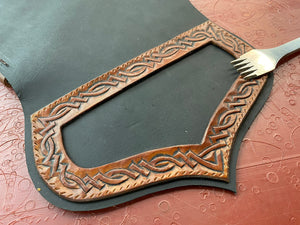 
                  
                    Detail of leather tooled knotwork on vegetable tanned leather; leather stitching marking tool.
                  
                