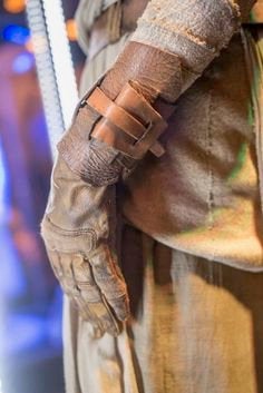 
                  
                    Detail image of brown leather cuff on arm of rey, from star wars, the force awakens.
                  
                