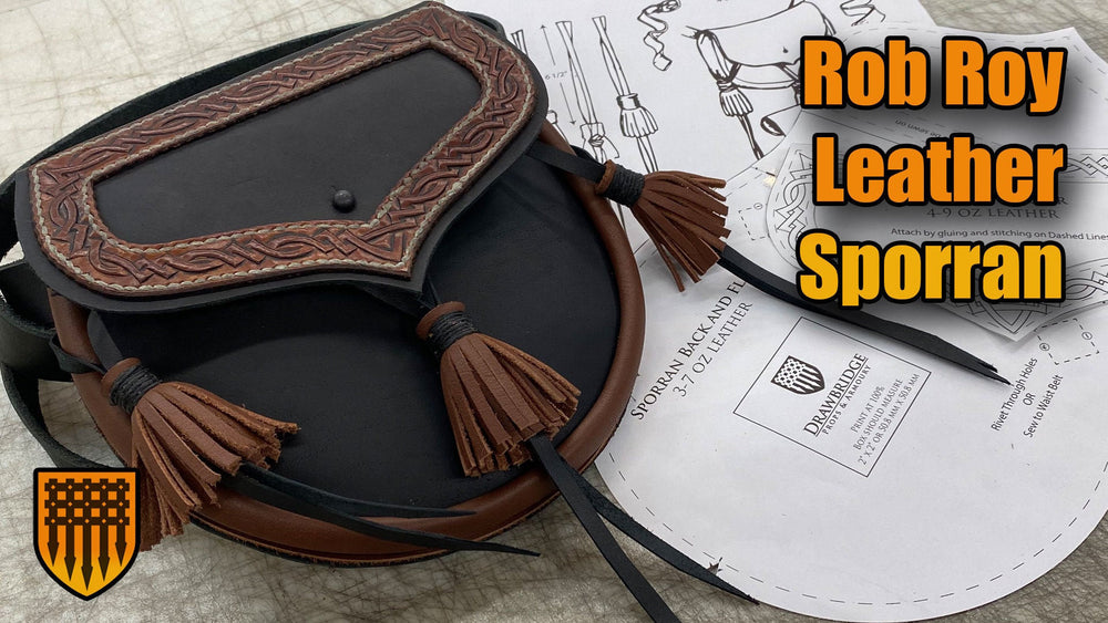 Black and brown Rob Roy Leather Sporran pouch with three leather tassels and tooled leather knotwork detail sitting on pattern pieces. from Drawbridge Props and Armoury.